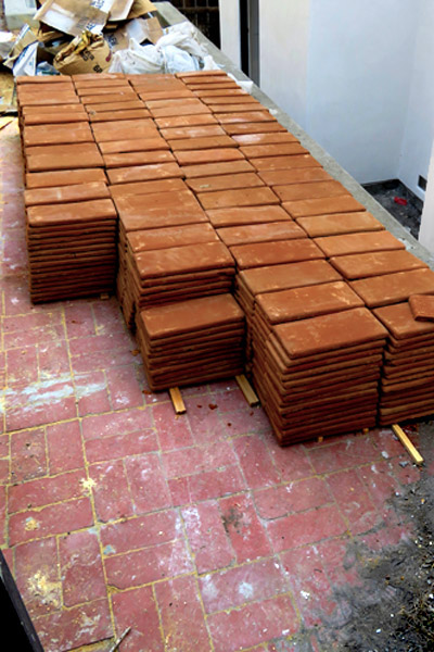 a Large Quantity of Handmade Rectangular Terra Cotta Clay Floor Tiles Stacked in Neat Rows at a Spanish Home Renovation Job Site in Santa Barbara, Ca