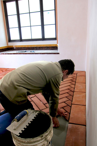a Master Tile Setter from Santa Barbara California Artistically Pieces Together a Herringbone Pattern Clay Floor in a Montecito California Spanish Colonial Revival House Renovation