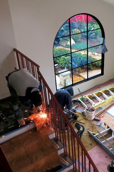 a Local Welding Team Fabricates a Modern Spanish Railing Design on a Staircase Next to a Large Arch Top Picture Window in Santa Barbara, Ca