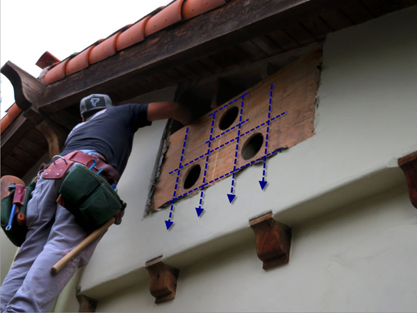 A Santa Barbara carpenter framing the openings for clay vents in a Spanish-style home in Santa Barbara, CA.