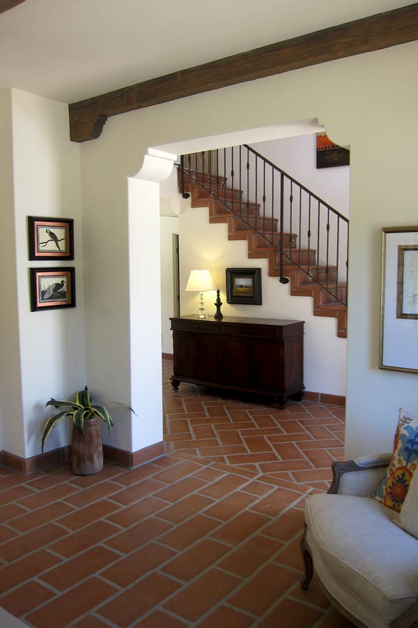 A spanish entry foyer in santa barbara with oversized terracotta clay floor tiles