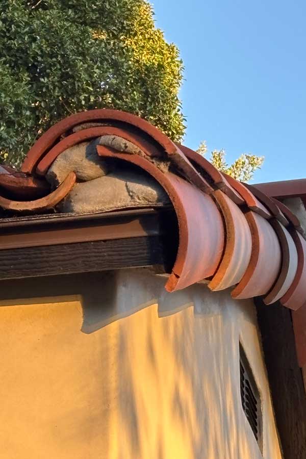 A close up of spanish roof tiles installed on the gable end of a spanish shed in santa barbara, ca