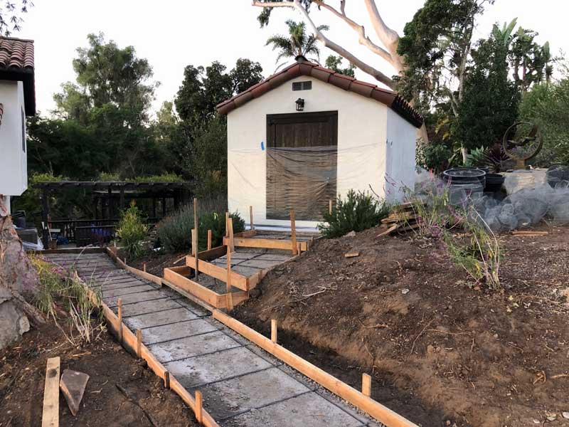 Wood forms and rebar in prep for concrete sidewalk and steps to spanish shed in santa barbara landscape