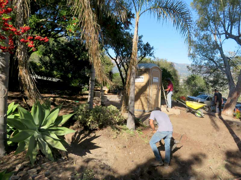 A santa barbara landscape crew clears land around location for a new spanish shed.