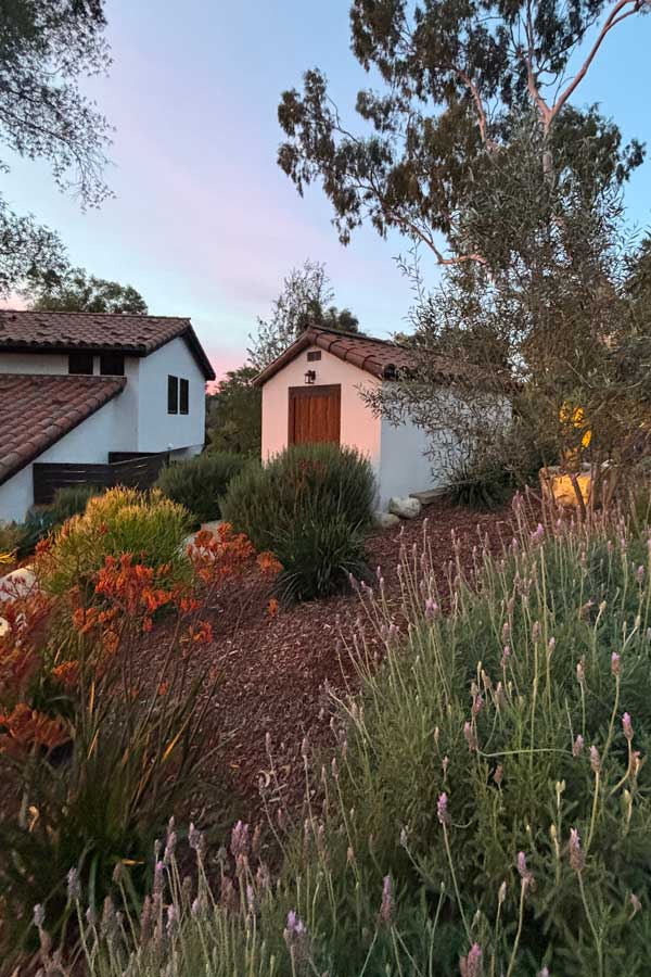 A santa barbara spanish garden shed exterior and landscape ties in with main house