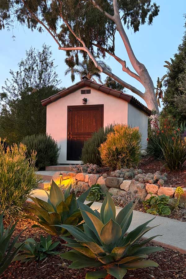 High-end spanish shed with stone retaining wall and agaves