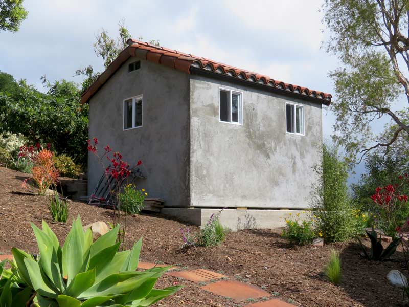 The "brown coat" of stucco is applied to a spanish shed in the making in santa barbara, ca